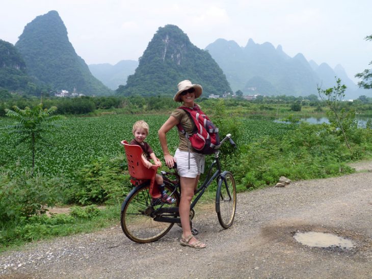 Clare on a tandem cycling along the river near Yangshuo, China