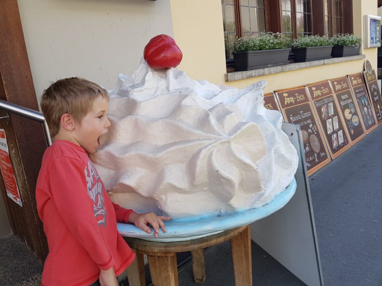 Jetson sampling a huge meringue in Switzerland